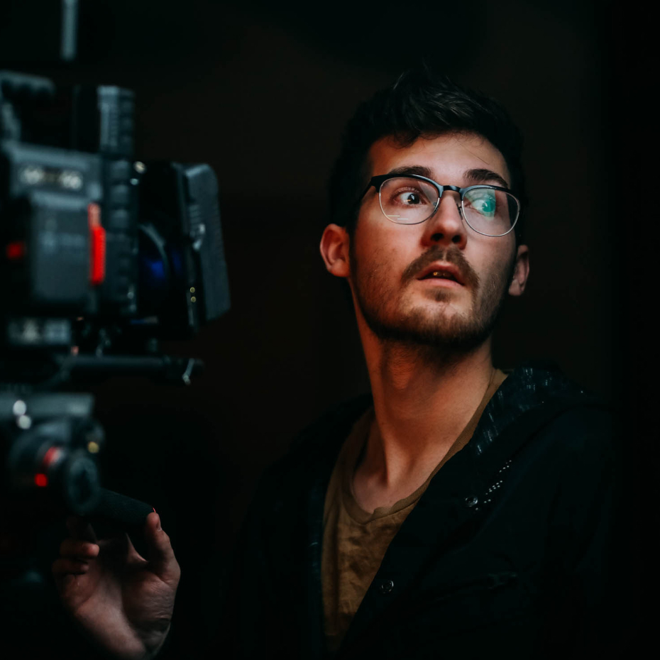 A videographer operates a camera on a production shoot.